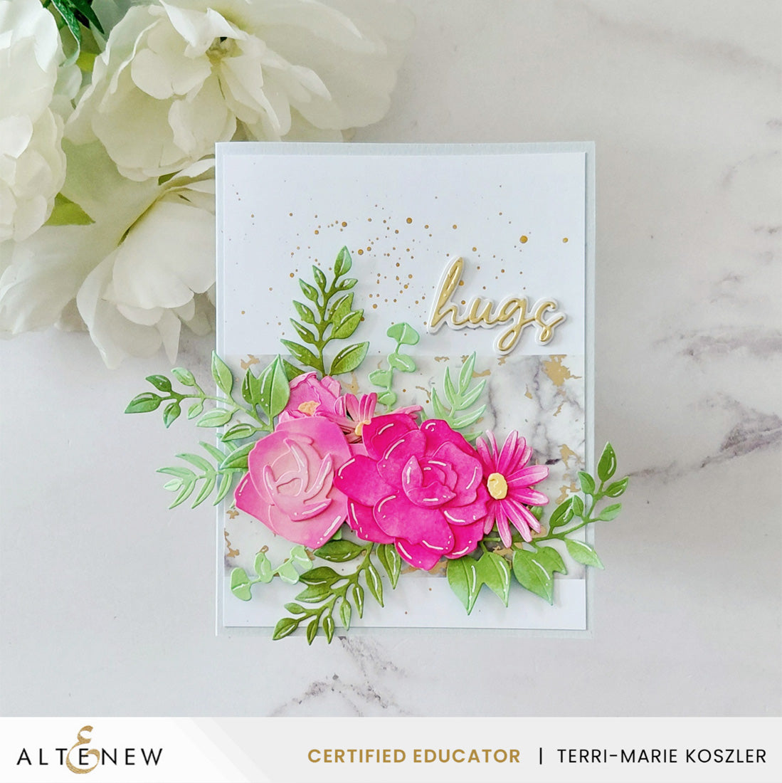 A handmade greeting card with layered pink paper flowers, green leafy stems, gold glitter, and the word 'hugs' in gold script, displayed on a light marble surface with white flowers in the background. Alteneew branding and a certified educator badge are visible at the bottom. Altenew EZ Arrangement: Garden Mix Layering Die Set card ideas