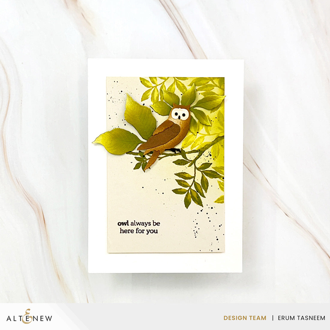 A handmade greeting card featuring a brown owl perched on green leaves, displayed on a white marble surface. The card has a white border and the text 'owl always be here for you' printed in black.