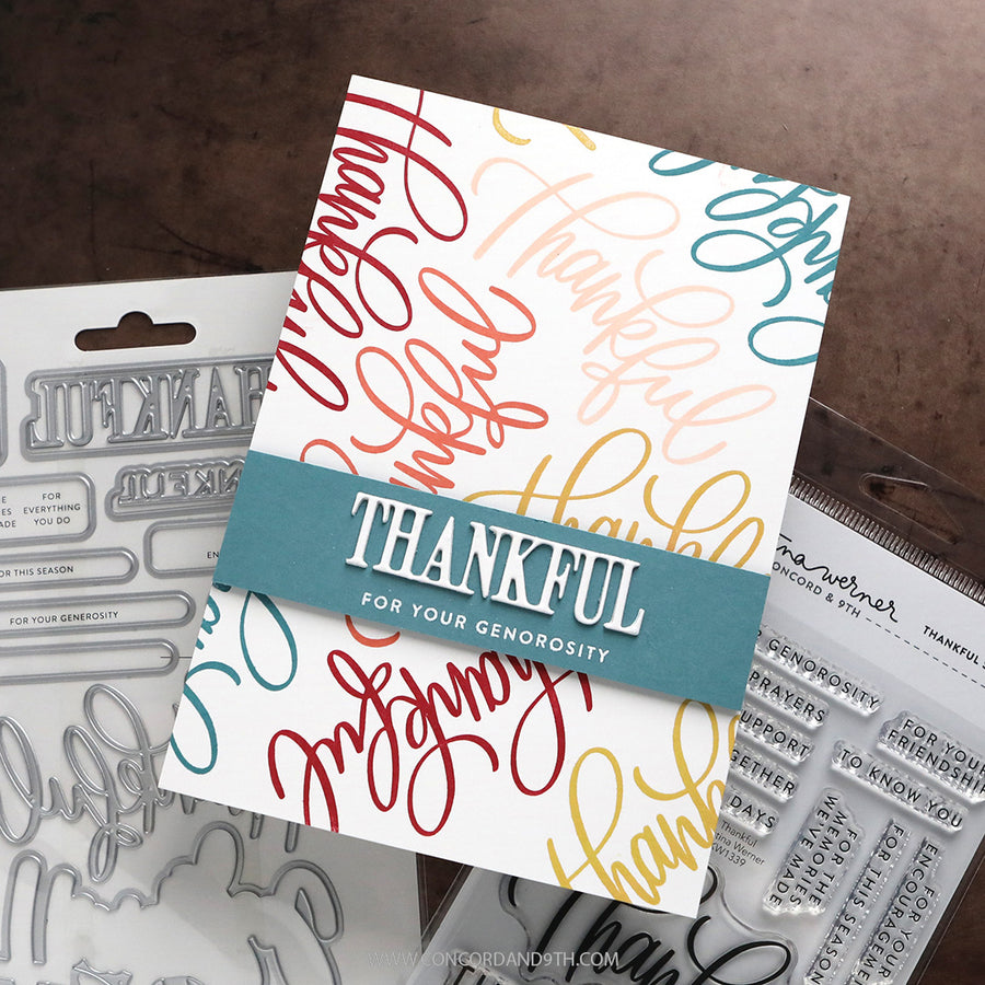 A handmade thanksgiving-themed card featuring colorful script text and a teal banner reading 'THANKFUL FOR YOUR GENEROSITY', shown with metal and clear stamp dies and a stamp block in the background.