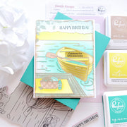 Birthday card with illustrations and 'Happy Birthday' text, surrounded by rubber stamps on a light background.