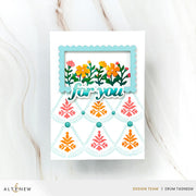 A handmade greeting card with a white base, featuring a scalloped light blue frame at the top containing colorful flowers and the words 'for you' in layered script. Below, a fan-shaped cutout design displays pink and orange floral motifs with small teal beads.