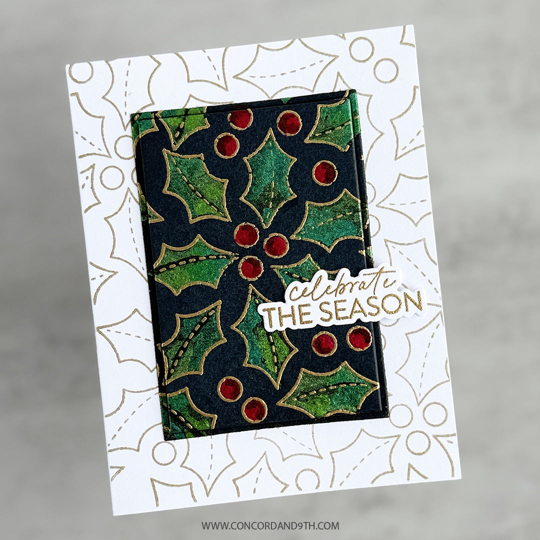 A handmade greeting card featuring a central rectangular panel with a green and black holly pattern and red berries, layered over a white card with gold holly outlines. A die-cut sticker reads 'celebrate THE SEASON' in white and gold.