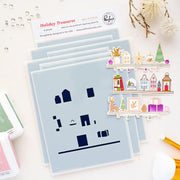 A set of layered holiday-themed stencils  titled Holiday Treasures from Pinkfash Studio, including house and furniture shapes on a light blue backing, with a sheet of colorful illustrated holiday shelf designs on the right. The products are arranged on a white surface with decorative elements like ink pads, beads, and dried flowers.