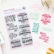 A sheet of clear holiday-themed stamp sentiments displayed on a white background, with multiple color variations of the same phrases printed beside it. The sheet reads 'Treasured Greetings' by Pinkfresh Studio and shows festive sayings like 'Peace and joy in your heart,' 'Wishing you a joyful Christmas,' and 'May your holidays be filled with Christmas joy.