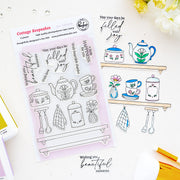 A sheet of clear stamp designs with floral tea-themed illustrations and phrases, displayed on a white surface alongside an example stamped design. The packaging reads 'Cottage Keepsakes' and '8-piece clear stamp' by Pinkfresh Studio.