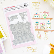 Cottage Keepsakes press plates by Pinkfresh Studio with tea-themed designs, displayed alongside sample stamped and stamped-out results on a white background with decorative gold text and small craft props.