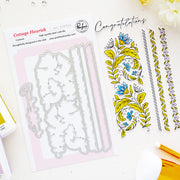 A flat-lay product shot of a steel cutting dies by Pinkfresh Studio called Cottage Flourish, showing the metal cutting dies on a sheet next to sample stamped floral designs and decorative borders on a white background.