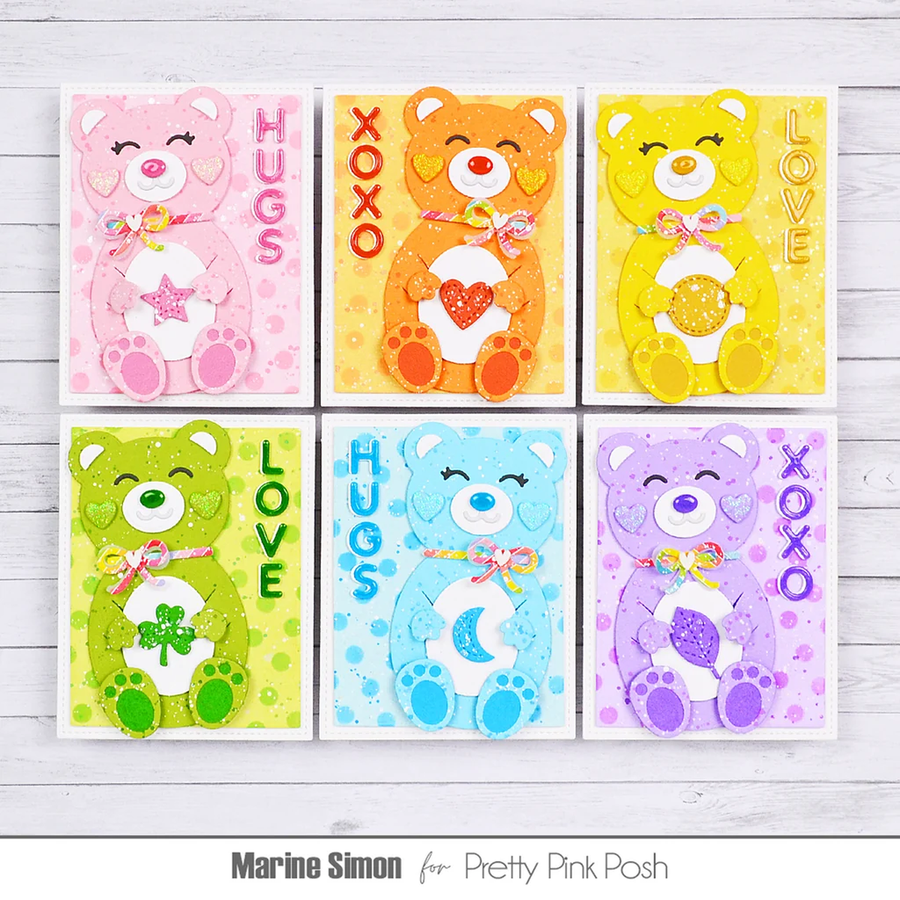 Six handmade colorful teddy bear greeting cards arranged in a 2x3 grid on a white wood background. The cards feature different bear designs in pink, orange, yellow, green, blue, and purple, with text reading HUGS, LOVE, XOXO, and names Marine Simon and Pretty Pink Posh.