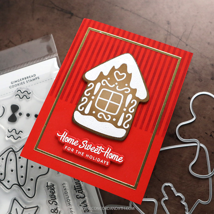 A handmade Christmas gingerbread house card with a red striped background, gold border, and a raised gingerbread house topper. The card reads 'Home Sweet Home FOR THE HOLIDAYS' in white script.