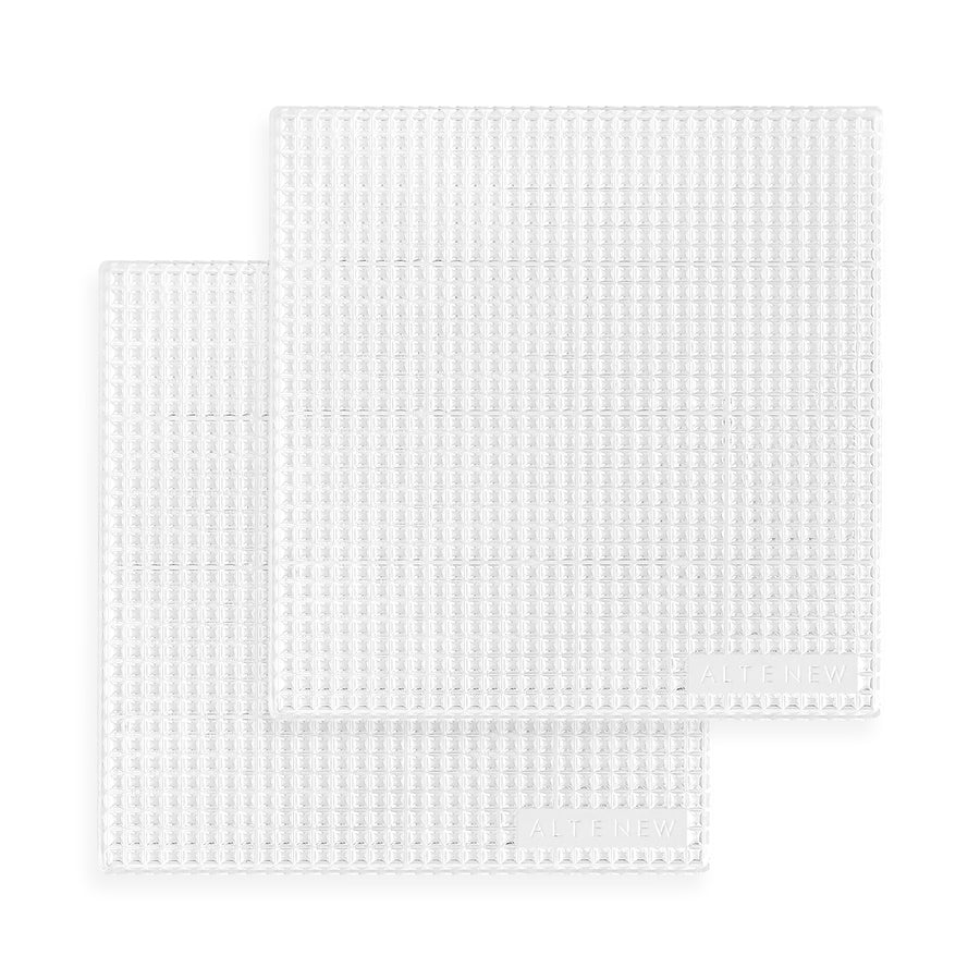 Two square white textured grip mats with a raised waffle pattern, stacked slightly offset on a clean white background. Altenew The Original Sticky Coaster: 4" x 4" (Classic Grid)