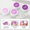 Four small round jars of ink with white lids and purple labels are arranged on a light marble surface. The labels read Althea New and scent names including Disheled Clover, Alpine Heather, Wild Orchid, and Bramble Berry. Altenew Highland Flora Fresh Dye Ink Mini Pods