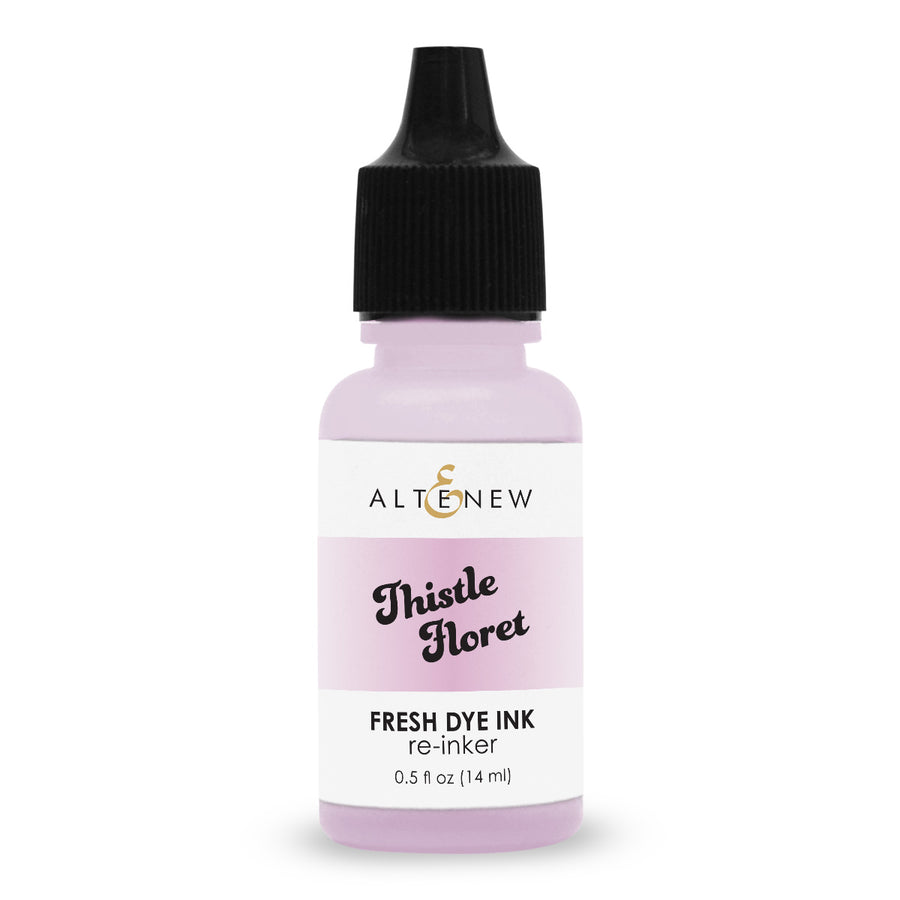 An Altenew Thistle Floret fresh dye ink re-inker bottle with a black cap and a white label featuring a light pink band, on a white background.