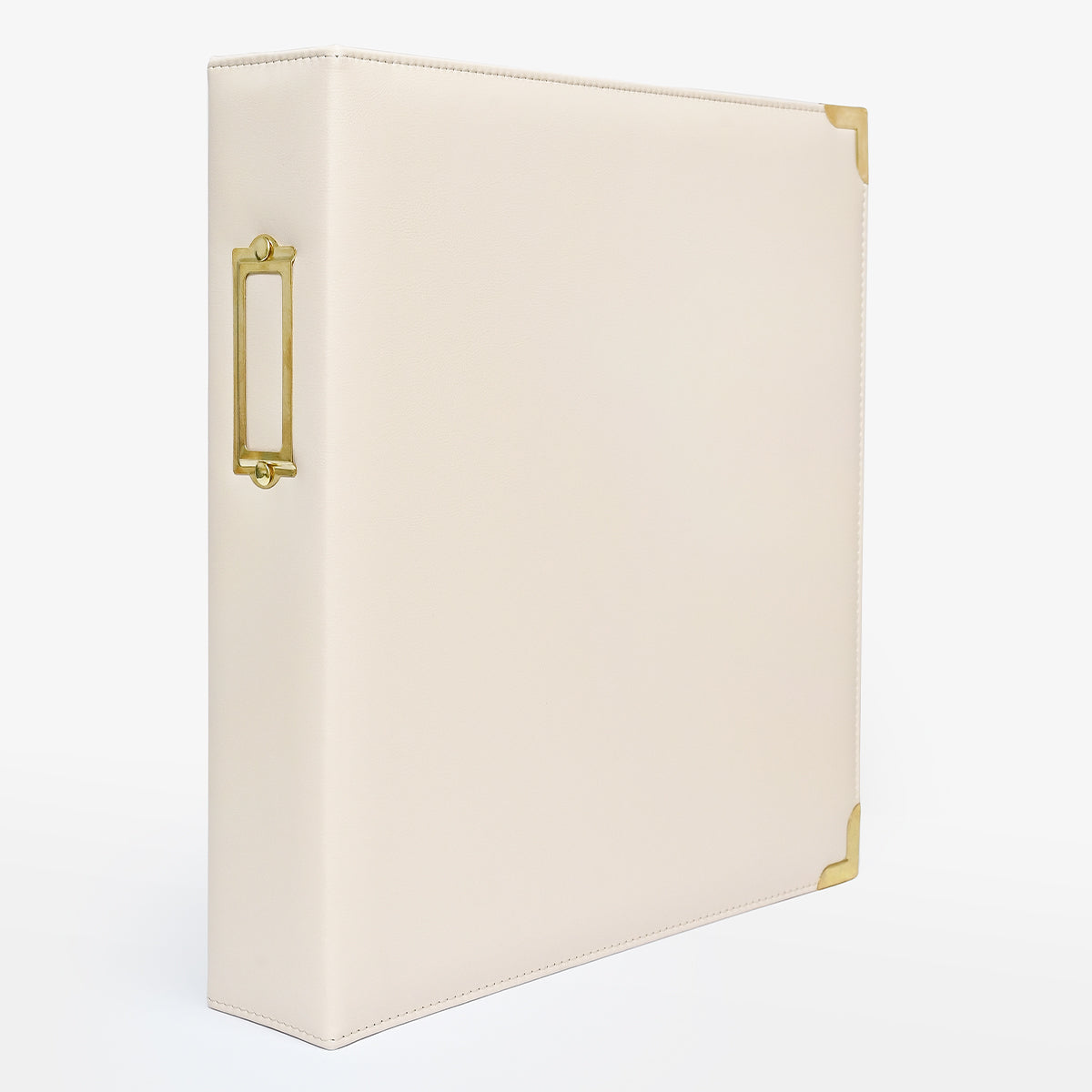 An ivory-colored faux leather ring binder with gold-tone metal accents, including a decorative side handle and corner protectors, shown on a clean white background. 