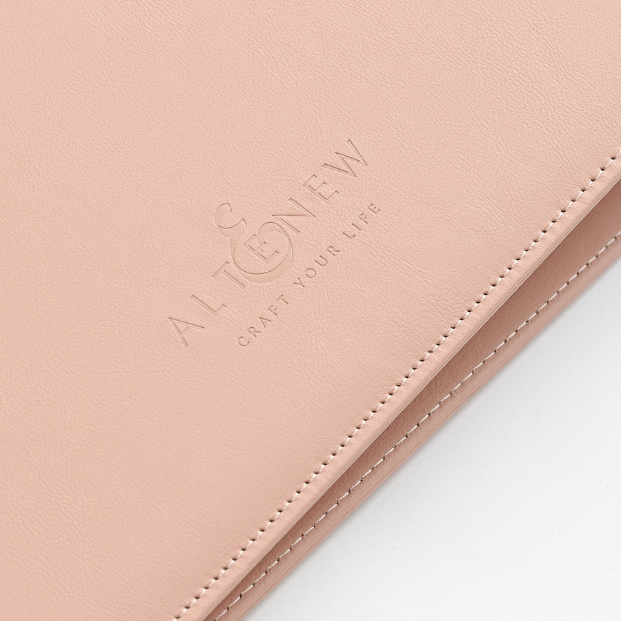 A close-up of a rouge faux leather or leather folio cover with white stitching and an embossed logo that reads 'ALTENEW CRAFT YOUR LIFE' on a white background.