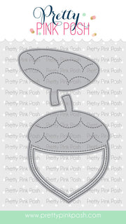 A die-cut craft design from Pretty Pink Posh featuring a gray acorn-shaped outline with dashed stitching details, shown on a white patterned background with the brand name at the top and a website footer. Pretty Pink Posh Acorn Shaker Dies