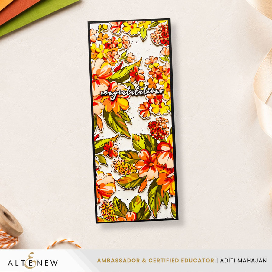 A rectangular handmade card with a colorful floral pattern and the word 'Congratulations' in script, displayed on a light textured background with craft props and a brand banner at the bottom. Altenew Build-A-Garden: Softly Sketched Blooms
