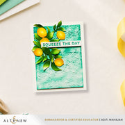 A handmade greeting card featuring a textured mint green background with yellow lemons and green leaves, and a white banner reading 'SQUEEZE THE DAY'. The card is displayed on a light beige textured surface with a white border and a brand banner at the bottom. Altenew Creative Cuts: Lemon Tree Layering Die Set card ideas