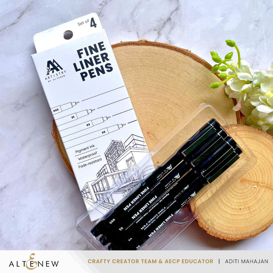 Set of 4 fine liner pens with packaging on a marble surface