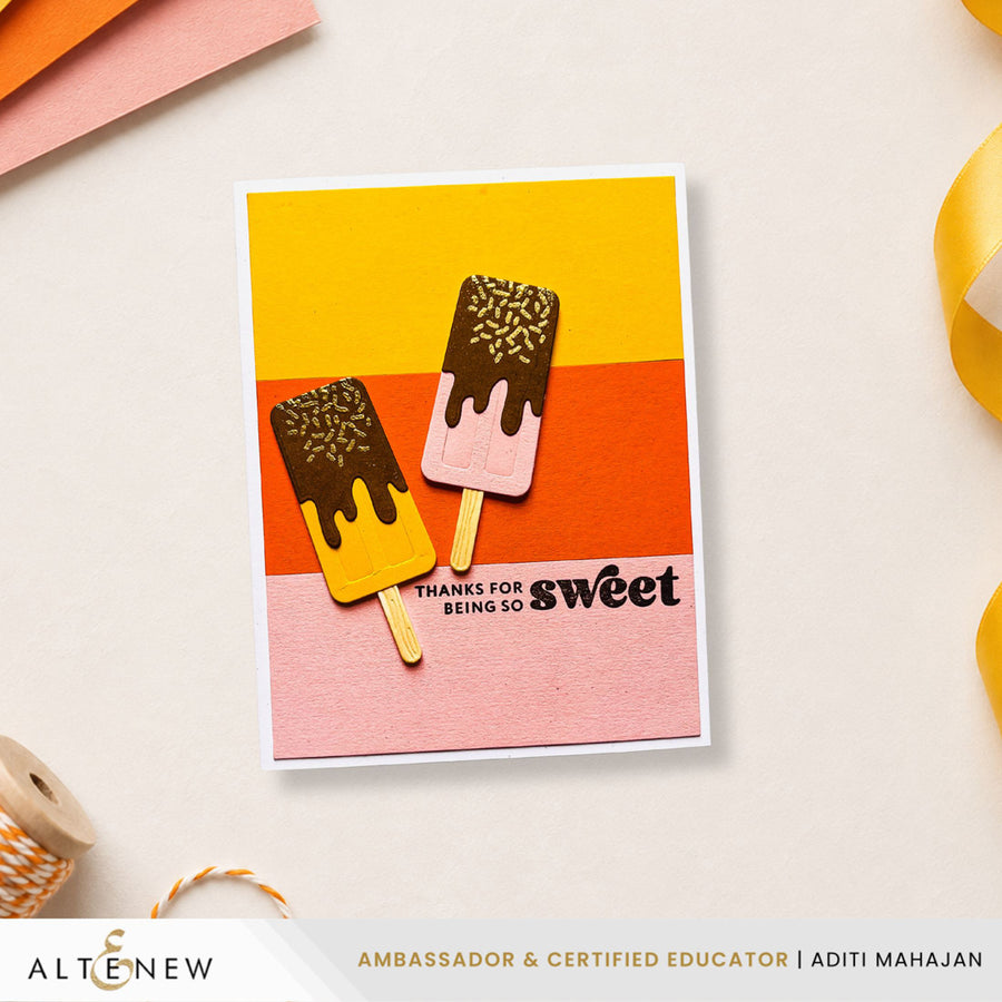 A handmade greeting card featuring two popsicle designs over yellow, orange, and pink horizontal stripes, with the text 'THANKS FOR BEING SO sweet' and 'ALTERNOW' branding visible on the card. Altenew Mini Delight: Sweet Popsicles Stamp & Die Set card ideas