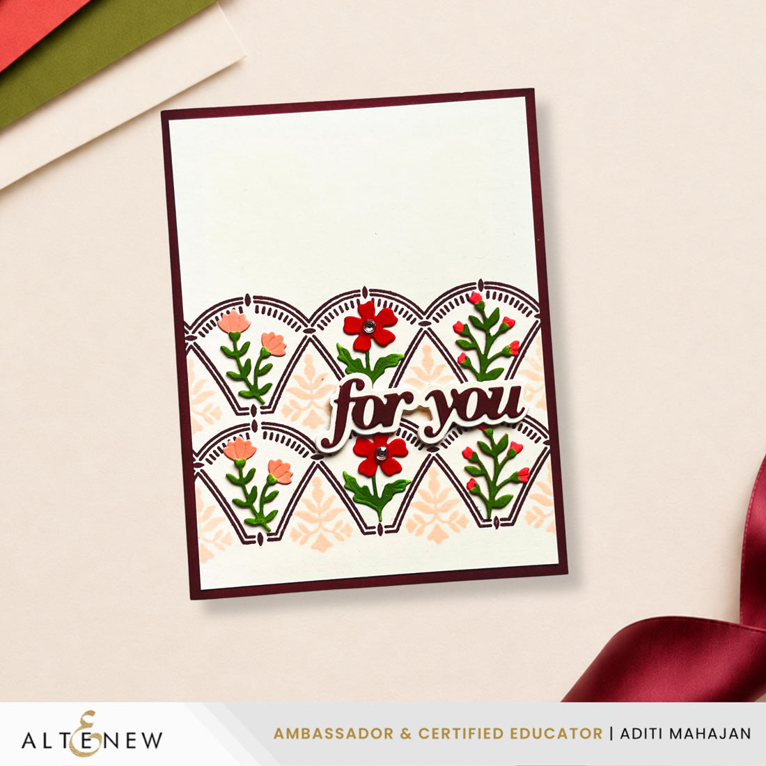 A handmade greeting card with a dark burgundy border, featuring a white center panel decorated with scalloped fan shapes, floral motifs in red, orange, and green, and the words 'for you' in script. The card is photographed on a light beige surface with decorative paper and ribbon props, and an ALTENEW banner appears at the bottom.