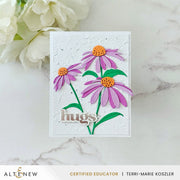 A handmade greeting card featuring three purple coneflowers with orange centers and green stems on a white textured background, with the word 'hugs' in metallic script. The card is displayed on a light marble surface next to white flowers, with an ALTENEW banner at the bottom. Altenew Craft-A-Flower: Coneflower Layering Die Set card ideas