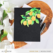 A black handmade greeting card featuring a 3D layered paper lemon design with green leaves and the text 'just a note', styled on a wooden slice with white flowers and pens. Altenew Creative Cuts: Lemon Tree Layering Die Set card ideas