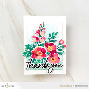 A handmade layered card featuring a watercolor-style floral arrangement in pink, red, and green with the words 'thank you' in black script, photographed on a light marble surface. Altenew Craft Your Life Project Kit: Painterly Perfection card ideas