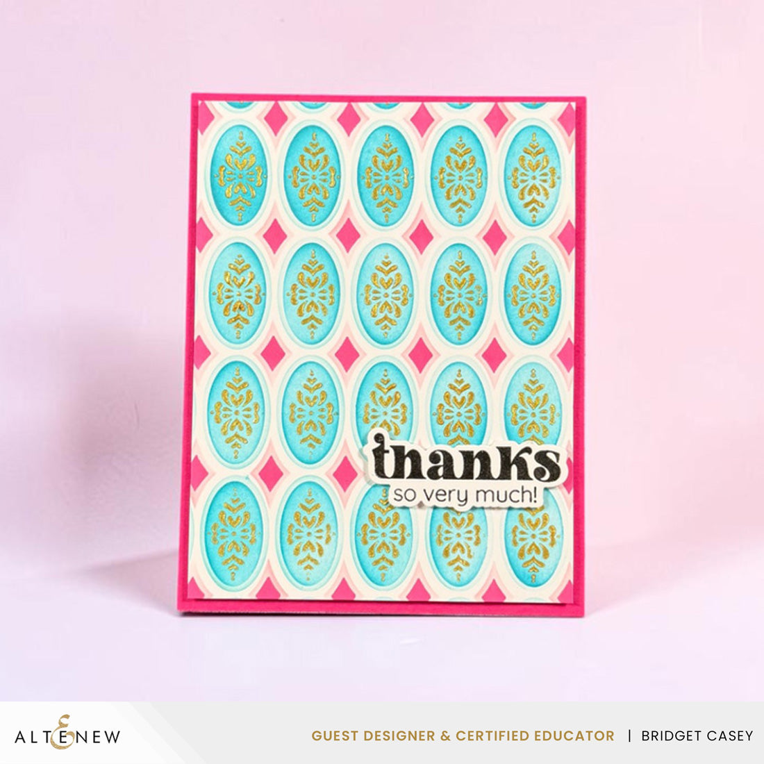 A handmade greeting card with a pink and teal patterned design, featuring the text 'thanks so very much!' on the front, displayed against a soft pink background.