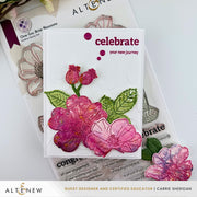 A handmade greeting card featuring pink and magenta embossed flowers with green leaves on a white background, with the words 'celebrate your new journey' printed in dark pink. The card is displayed on top of Altenew crafting materials and stamps. Altenew One-Go: Briar Blossoms card ideas