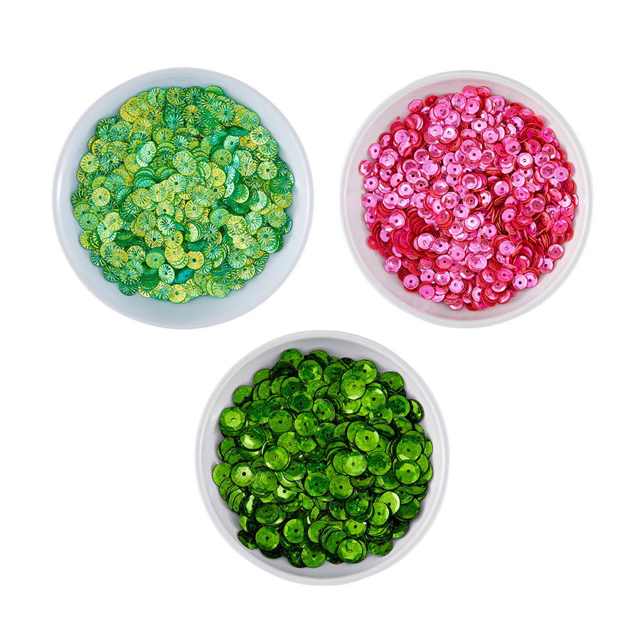 Three small white bowls filled with round sequins, arranged on a white background: one green-and-yellow mix, one bright pink, and one vivid green. Spellbinders Festive Felt Christmas Sequin Bundle