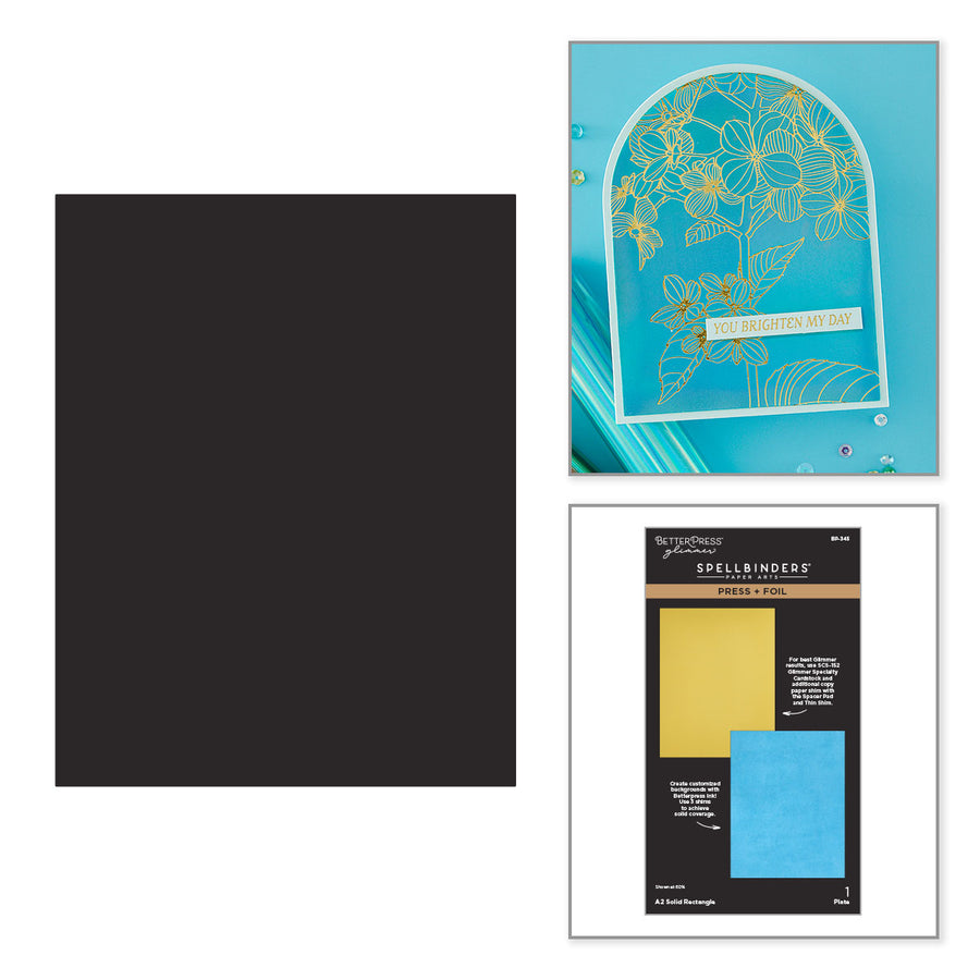 A craft kit display featuring a solid black cardstock sheet on the left, a turquoise layered card with gold foil floral details on the top right, and the Spellbinders Scrapbook Paper package on the bottom right. Spellbinders A2 Solid Rectangle Press + Foil Plate