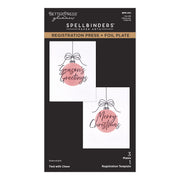 BetterPress Glimmer Spellbinders Paper Arts Registration Press and Foil Plate package, featuring two sample holiday cards with pink ornament graphics and black text on a black card backing. Spellbinders Tied with Cheer Registration Press + Foil Plate