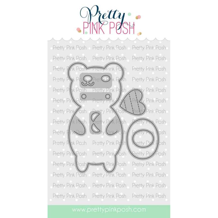 A metal die-cut featuring a bear outline with a stitched heart patch, shown on a white background with repeated Pretty Pink Posh branding and a mint footer. Die is called Bear Holder.