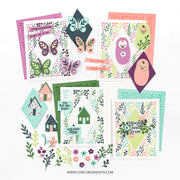 A flat lay of six handmade baby shower cards with matching decorative cutouts, butterflies, houses, flowers, and leaves, arranged on a white background with the website Concordand9th.com printed at the bottom.
