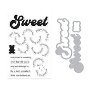 A clear stamp sheet with black holiday-themed phrases and a gray metal die cut matching the word 'Sweet' and decorative motifs, shown on a plain white background.