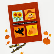 A handmade autumn-themed greeting card with a rust-orange background and four colorful square illustrations: sunflowers, a scarecrow, a black bird, and pumpkins. A black banner across the center reads 'WITH A WARM & THANKFUL HEART. Using Hero Arts Beep Beep Leaf Peeper Die Set