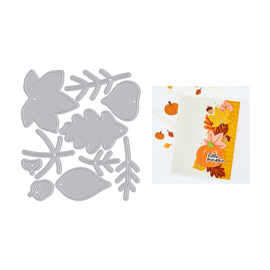 An autumn-themed die-cut card set shown on a white background, featuring a gray metal die sheet with leaf, pumpkin, acorn, and branch shapes alongside a finished handmade card decorated with layered orange, yellow, and brown fall leaves and pumpkins.