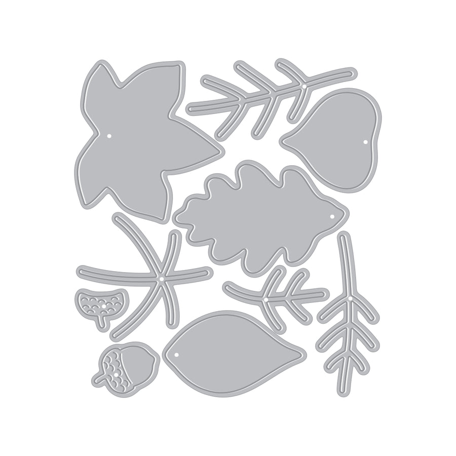 A set of gray metal die-cut shapes featuring autumn leaves, acorns, and twig branches, arranged on a solid white background.