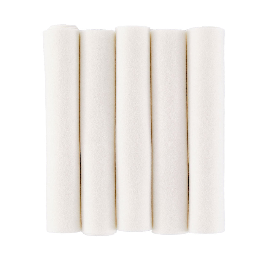 Five rolled sheets of off-white felt fabric standing vertically side-by-side on a plain white background. Spellbinders Merino Wool Felt Sheets - Snow