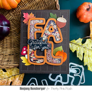 A handmade layered card featuring the word 'FALL' in large letters filled with autumn-themed bead patterns, surrounded by leaves, acorns, a mushroom, and the phrase 'Grateful for you!' on a dark background, styled with fall props and metal dies.