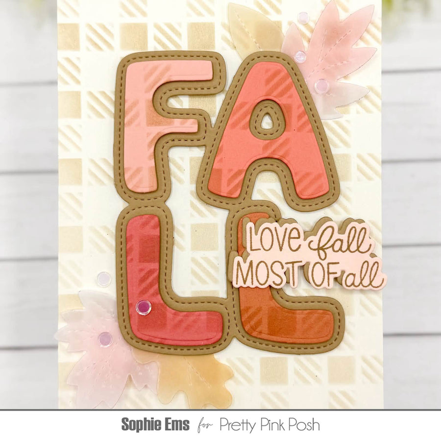 A handmade autumn-themed card featuring large die-cut letters spelling 'FALL' in shades of pink, coral, and orange with tan borders, layered over a cream patterned background with decorative fall leaves and the phrase 'Love fall MOST of all'.
