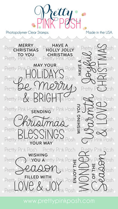 A sheet of Pretty Pink Posh photopolymer clear stamps featuring various Christmas-themed phrases in black and blue script and serif fonts, shown on a white background with a light gray patterned backdrop. Pretty Pink Posh Inside Sentiments: Christmas Stamp Set