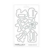 A sheet of metal cutting dies on a white backing card, featuring gingerbread cookie shapes and hearts. The brand name 'Kristina Werner' is visible at the bottom of the card.