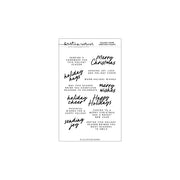 A sheet of holiday-themed clear stamps with black printed text and phrases such as 'Merry Christmas,' 'holiday joy,' 'happy holidays,' and 'sending joy' on a white background.
