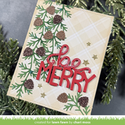 A handmade Christmas greeting card with 'Merry' in red glitter script and block letters, layered over green pine branches, brown pinecones, and gold star embellishments on a beige plaid background. The card is photographed among green pine needles, with a green banner at the bottom reading 'created for lawn fawn by chari moss'.