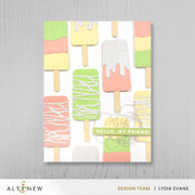A handmade greeting card featuring a playful pattern of colorful popsicle sticks on a white background, with the text 'HELLO, MY FRIEND!' across the center. The print is shown against a light gray wood-textured background, with branding at the bottom reading ALTNEW and DESIGN TEAM | LYDIA EVANS. Altenew Mini Delight: Sweet Popsicles Stamp & Die Set card ideas