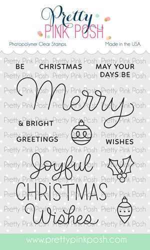 A sheet of Pretty Pink Posh photopolymer clear stamps featuring Christmas-themed phrases and ornaments, shown on a white background with the brand name at the top and a website URL at the bottom. Pretty Pink Posh Merry Greetings Stamp Set