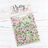 A clear plastic bag filled with pastel pink, green, and white round craft sprinkles, sealed with a white header card printed with the brand name 'Pretty Pink Posh' on a white wood-textured background. Pretty Pink Posh Mistletoe Kisses Shaker Beads