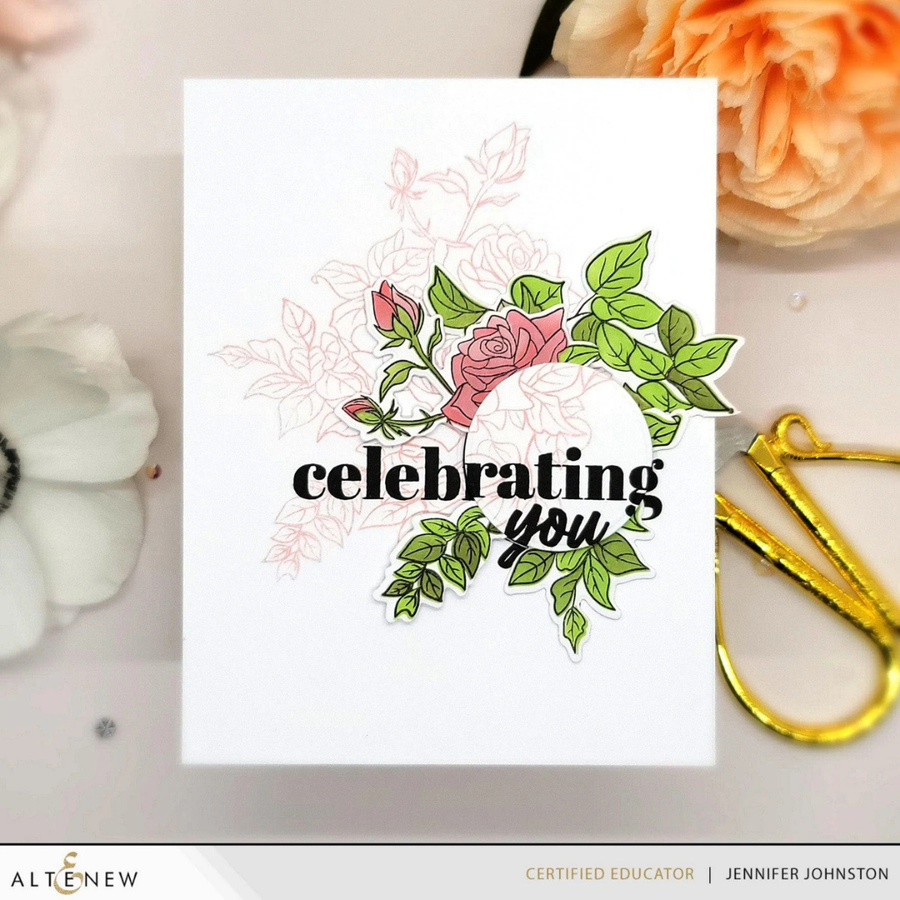Card with floral design and 'celebrating you' text on a decorative background with flowers and a gold ribbon.