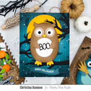 A handmade Halloween greeting card featuring a brown owl with large white eyes and yellow feet, perched on a black branch in front of a yellow moon and teal starry background. The card reads 'BOO' and 'HAPPY HALLOWEEN.